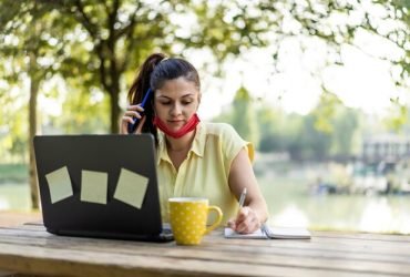 young-woman-using-mobile-phone-while-sitting-table_1048944-29230424